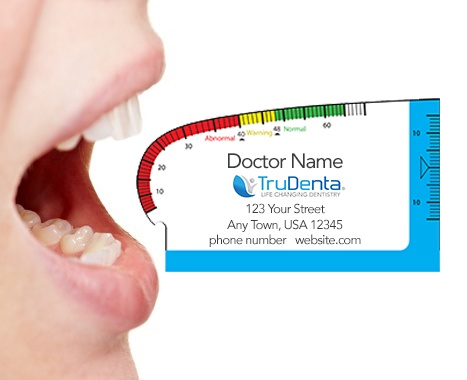 close up of persons mouth with measuring chart to right