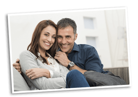 Smiling couple sitting on a couch