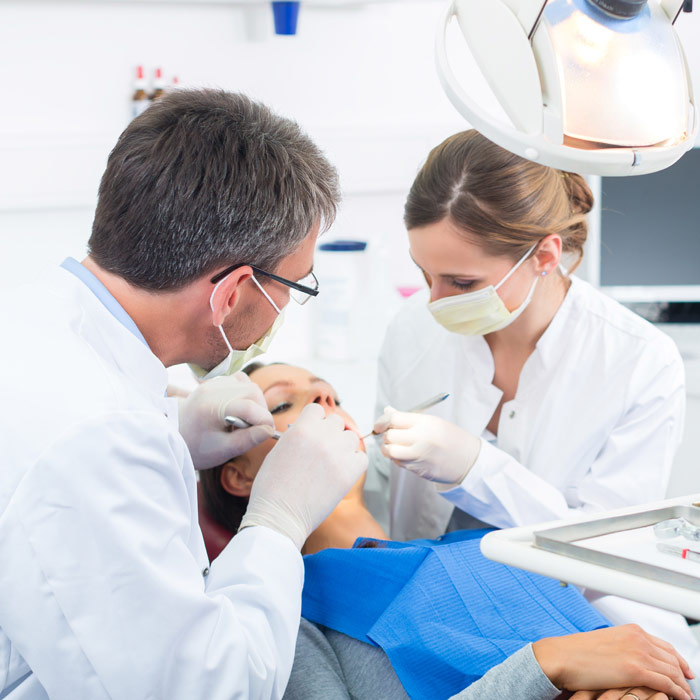 Dentist cleaning a patients teeth