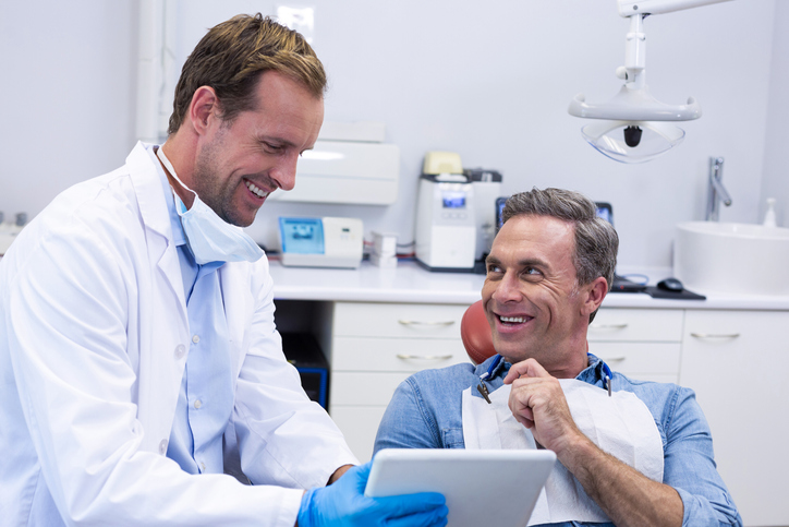 Doctor and patient reviewing medial data on tablet