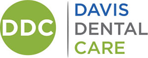 Davis Dental Care Logo - Dark blue gray and green sans-serif type with circle and initials inside to left