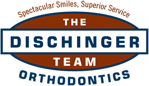 Dischinger Orthodontics Logo - Dark blue and white sans-serif type with dark red oval in background