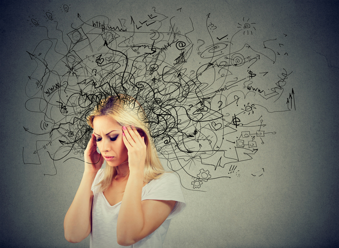 A woman holding her temples with illustrated crazy black lines coming from her head