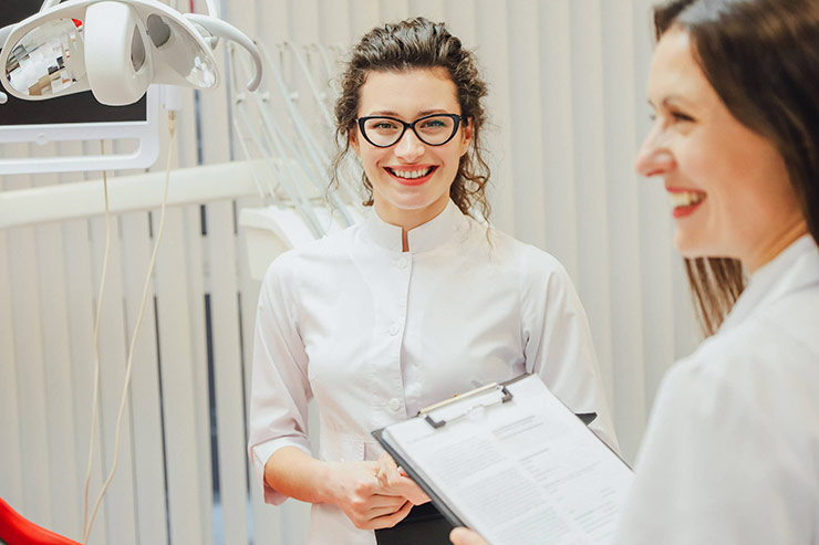 Two female doctors smiling in examination room