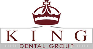 King Dental Group Logo - Dark red serif type with gray box around it and dark red crown above