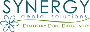 Synergy Dental Solutions Logo - Green and blue sans-serif type with flower as a text divider