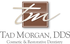 Tad Morgan DDS Logo - Brown serif type with brown square and script initials inside at the top