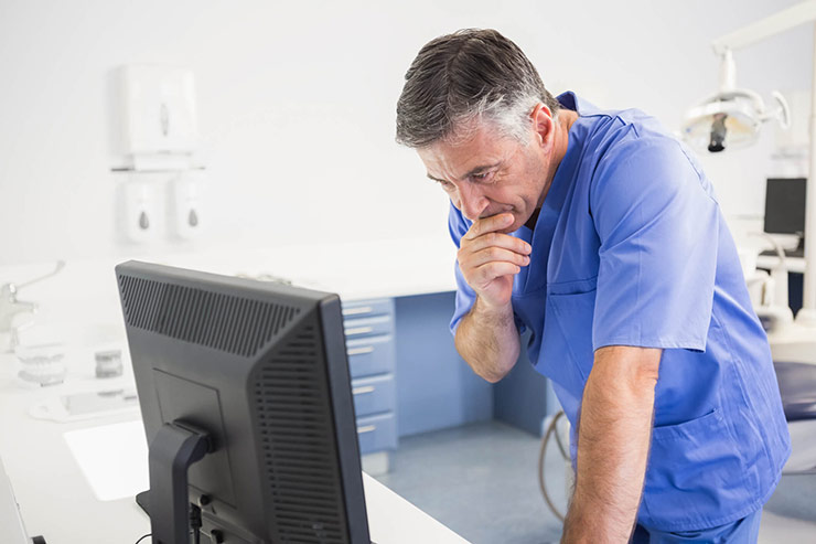 Doctor looking at computer monitor