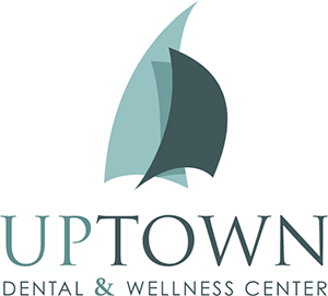 Uptown Dental and Wellness Center Logo - Light and dark seafoam serif type with sans-serif tagline below and ship sails on top