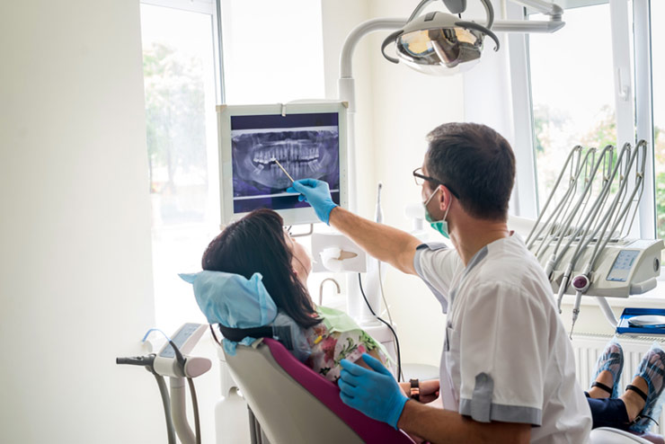 Technician showing patient their x-rays