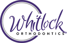 Whitlock Orthodontics Logo - Purple script type and black sans-serif type with with purple circle