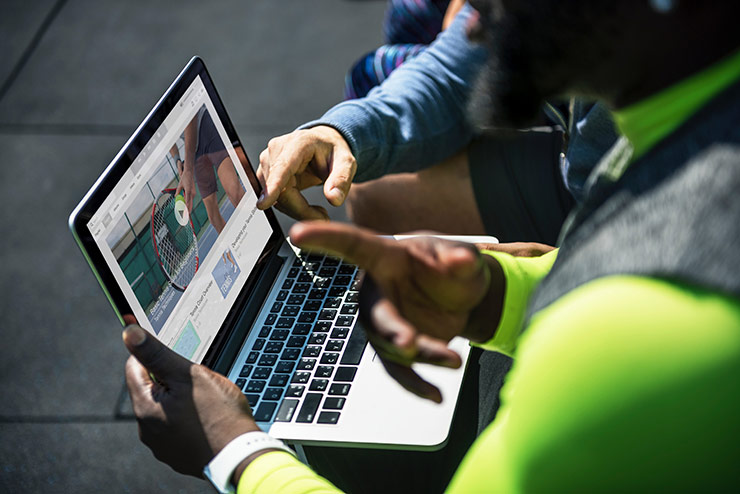 2 people looking at a laptop