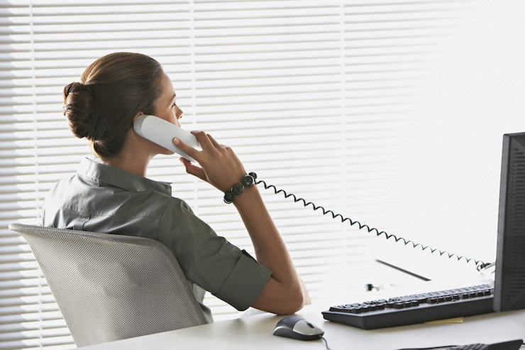 Woman at a desk talking on a phone